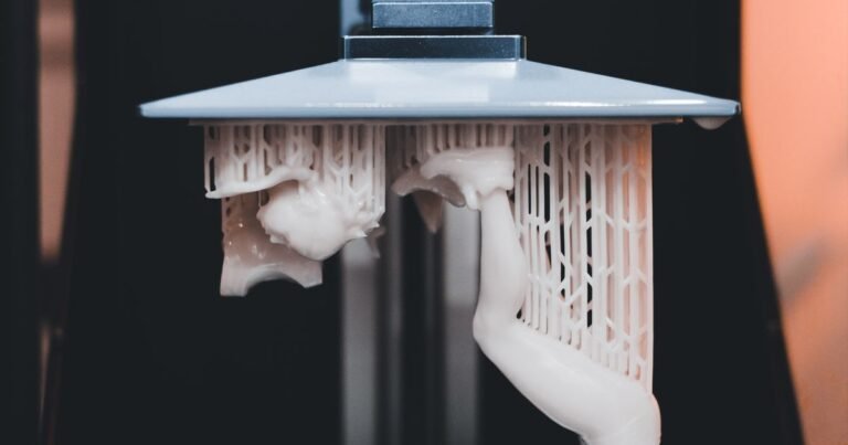 A resin 3D printer actively printing a dental appliance, close-up view.