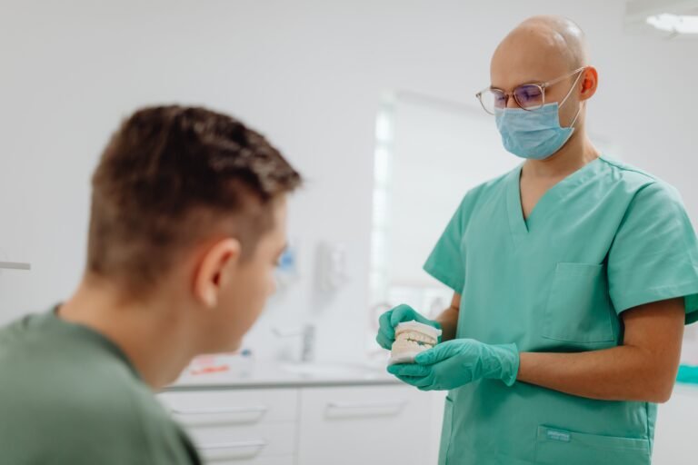 Dentist explaining a treatment plan to a patient during a dental consultation.