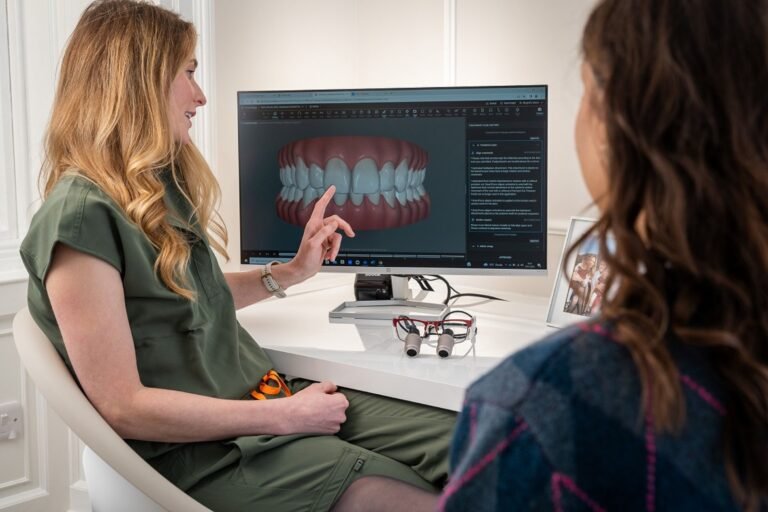 A dental professional displays a 3D dental model to a patient during a consultation appointment.
