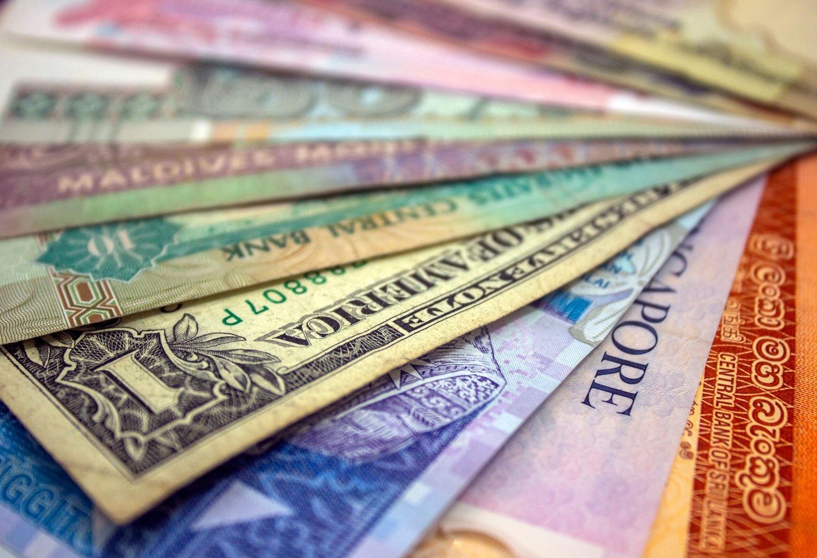 A close-up view of various international banknotes showcasing diverse currencies from several different countries