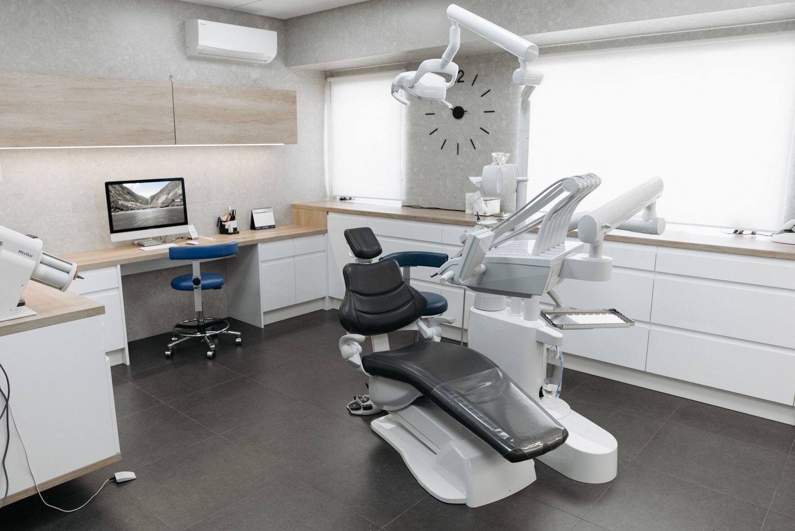 A modern dental clinic interior featuring a minimalist dental chair and professional equipment in a clean, contemporary medical space