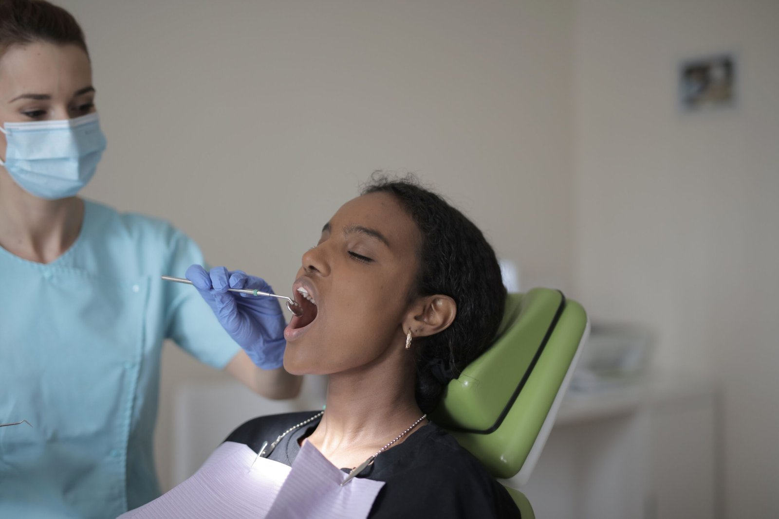 A dentist performing a dental examination on a patient in a clinic