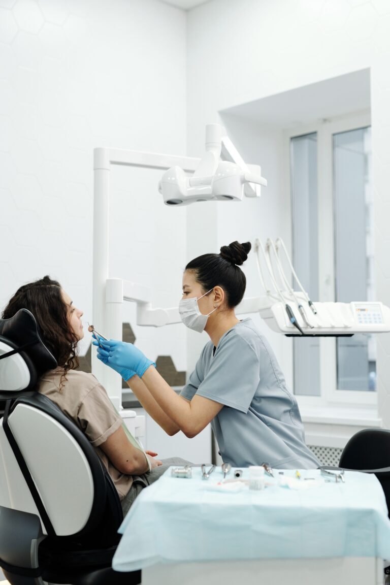 A dental professional conducting a routine oral exam on a patient in a modern clinic.